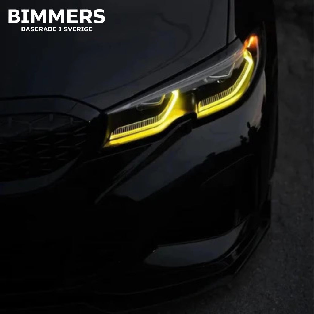 Närbild på en BMW G20 Standard LED-strålkastare med tända gula DRL-ljus (ej laserljus).