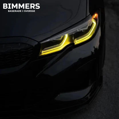 Närbild på en BMW G20 Standard LED-strålkastare med tända gula DRL-ljus (ej laserljus).