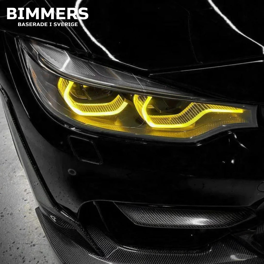 Närbild av gula LED DRL-moduler för BMW 4-serie, M3 och M4 årsmodell 2018-2020 installerade på svart BMW M4
